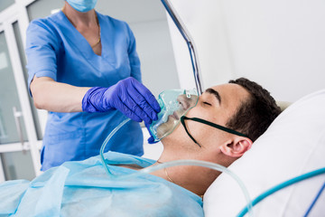 Wall Mural - Doctors give resuscitation to a male patient in the emergency room. Cardiac massage