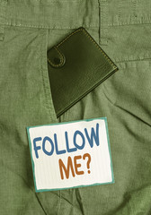 Handwriting text Follow Me Question. Conceptual photo go or come after demonstrating or thing proceeding ahead Small little wallet inside man trousers front pocket near notation paper