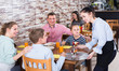 © JackF - Polite pretty waitress serving dishes to family