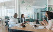 © mavoimages - Diverse group of businesspeople talking together inside of an office