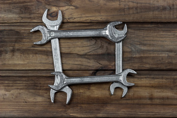 Wall Mural - set of wrenches on a wooden background, place for an inscription