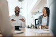 © mavoimages - Smiling African American businessman talking with colleagues during a meeting