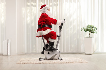 Sticker - Santa Claus exercising on a stationary bicycle