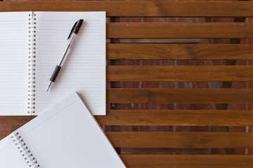 Wall Mural - Top view of Pen, notebook on the wooden table and copy space