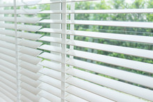 Close Up View Of Window With Horizontal Blinds. White Roller Blinds Or Louver Curtains At The Glass Window