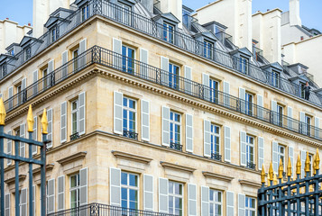 Residential lofts of the floor house with balconies and windows with shutters in the range of open forged gates