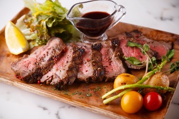 steak grilled beef with vegetables on the wood plate