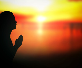 Wall Mural - Forgive concept: Silhouette prayer woman pray to God on autumn sunset background