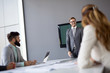 © NDABCREATIVITY - Business people having fun and chatting at workplace office