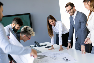 Image of business partners discussing documents and ideas at meeting