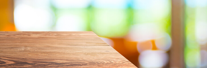 wood table top product display background with blur people in green cafe restaurant.left perspective wooden kitchen counter.Banner mockup presentation for your product online