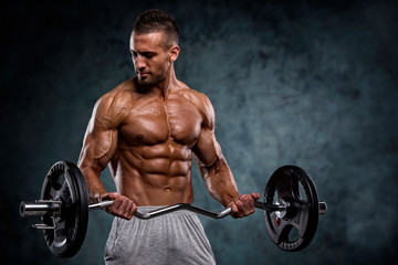  Muscular Men Lifting Weights. Studio Shot