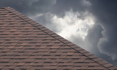 Poster - brown roof shingle on cloudy day in rainy season.