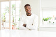 © Krakenimages.com - Handsome african american man on white table happy face smiling with crossed arms looking at the camera. Positive person.
