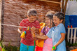 © Sergey Novikov - Kids play shooting water gun game, hot summer day
