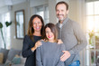 © Krakenimages.com - Beautiful family together. Mother, father and daughter smiling and hugging with love at home.