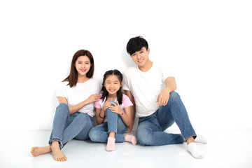 Wall Mural - Happy asian Young family Sitting On Floor