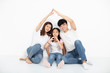 © Tom Wang - happy young family sitting on floor with home concept