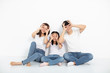 © Tom Wang - happy young family sitting on floor with looking gesture