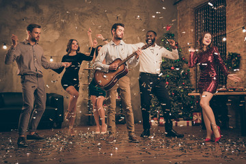 Wall Mural - Fulll length photo of funny fellows enjoy music dance celebrate christmas night x-mas party in house with confetti falling indoors