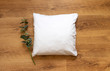 © StaCheck Photography - Blank pillow mockup on wooden floor background and eucalyptus plant prop