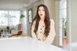 © Krakenimages.com - Young beautiful woman at home afraid and shocked with surprise expression, fear and excited face.