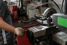 Mechanic Man Repairing Brake Use Lathe Tool Polishing Disc Brakes Of Cars Working Automatic. - Rebuild Disc Brake Surface.