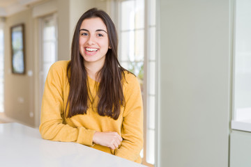 Wall Mural - Beautiful young woman wearing yellow sweater with a happy and cool smile on face. Lucky person.