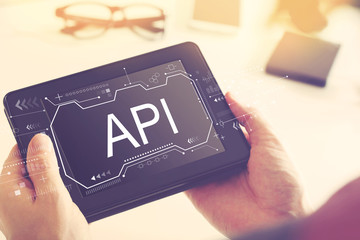 API concept with man holding a tablet computer