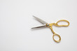 © Rawf8 - Scissors gold and silver isolated against white background