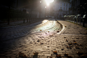 lowlight on a paved european street in fall