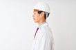 © Krakenimages.com - Chinese architect man wearing coat and helmet standing over isolated white background looking to side, relax profile pose with natural face with confident smile.