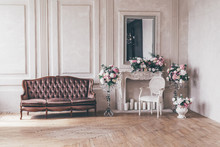 Vintage Interior Sofa With A Vase Of Flowers In Shabby Chic Style.