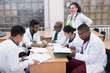 © Алексей Доненко - a group of young people of mixed race. Doctors in white coats sit at a table in the hospital's office, discuss medical issues and topics.