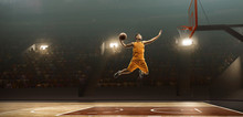 Professional Basketball Player On Sports Arena In Action With The Ball. Slam Dunk