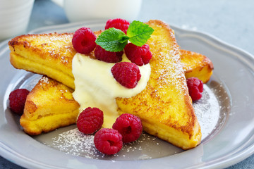 Wall Mural - French toast with english sauce and raspberries.