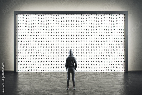 Woman looking at abstract digital background in modern loft space with concre...