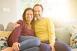 © Krakenimages.com - Middle age romantic couple sitting on the sofa at home