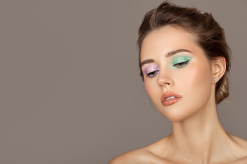 Fashion portrait of young woman. Colorful eye shadows. Perfect skin.