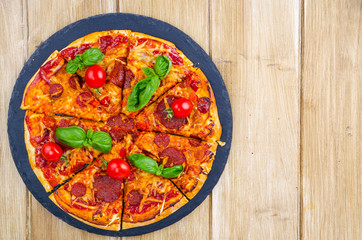 Wall Mural - Pizza with salami, cheese and fresh vegetables