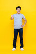 © Atstock Productions - Young good looking Asian man standing with thumbs up gesture