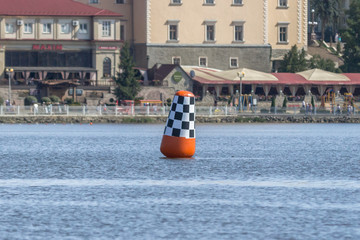 Pointer to the water. Buoy on a lake or river. Warning label. Attention to danger. Route and limiter at water competitions. Depth of a body of water, sea or ocean. Safety on the water.