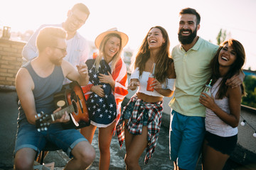 Wall Mural - Group of happy friends having party on rooftop