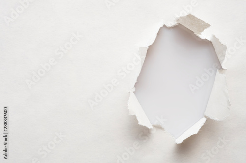 Fotografía A hole in old paper with the sides torn off