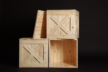 Wall Mural - Group of wooden crates on black background