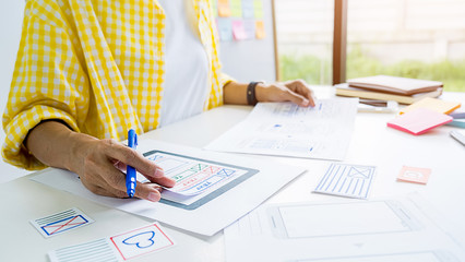 Creative Web Designer planning application and developing template layout, framework for mobile phone. User experience (UX) concept.