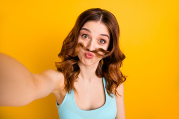 Wall Mural - Photo of lady making selfies with curl moustache playing like guy wear tank-top isolated yellow background