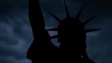 Statue Of Liberty: Time Lapse With Thunderstorm, Dark Clouds, Lightning And Iconic Monument In Silhouette, New York City, USA