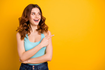 Sticker - Copyspace photo of charming cute nice cheerful emotional sweet gorgeous girlfriend wearing jeans denim teal singlet while pointing away at emptiness isolated with yellow vivid color background