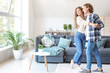 © Pixel-Shot - Happy young couple dancing at home